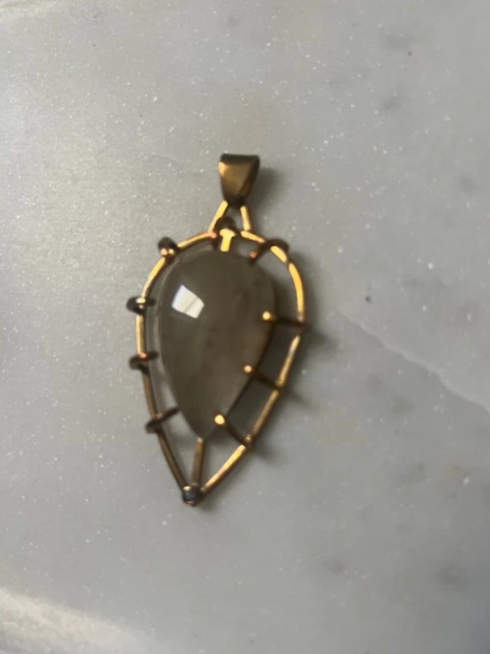 Stone and brass pendant